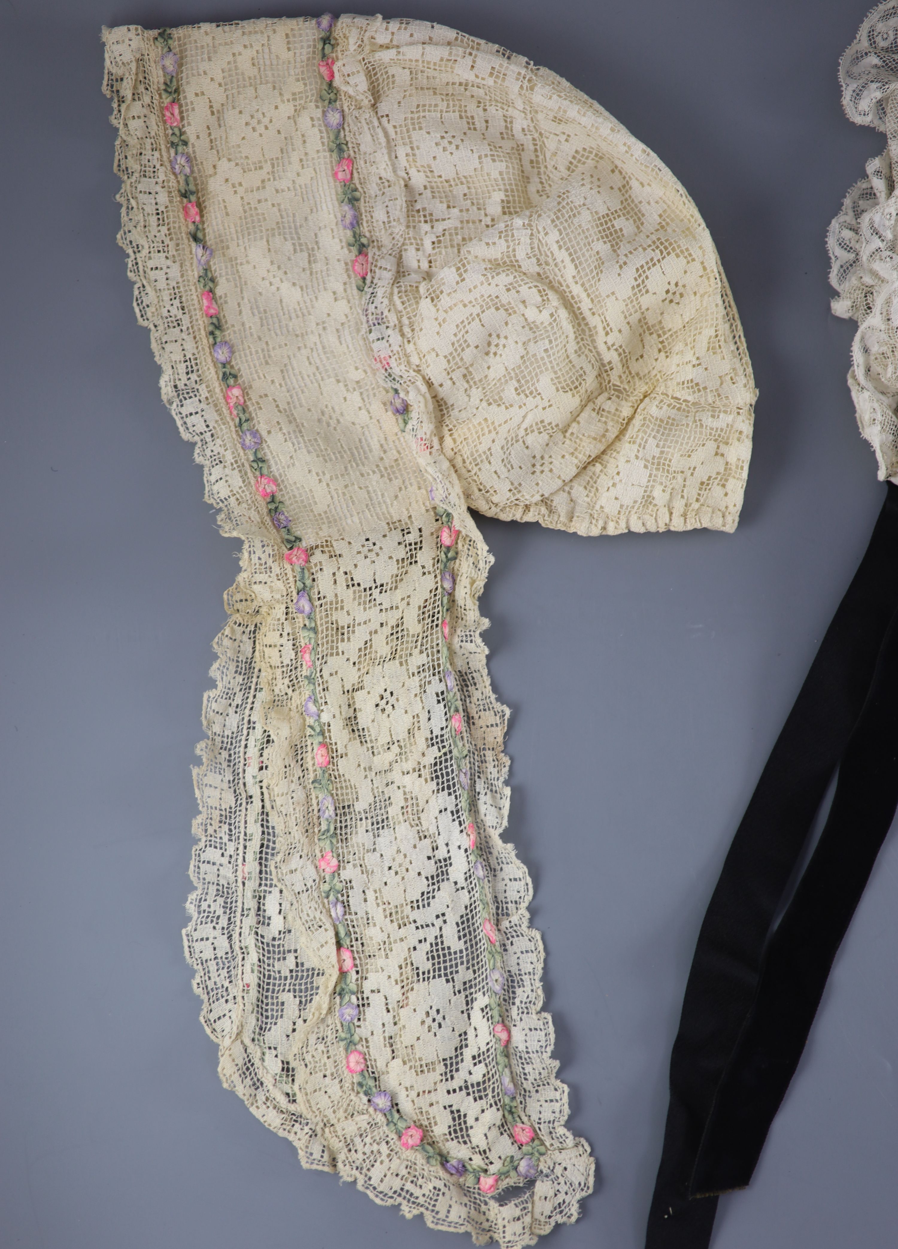 A fine white worked embroidered lace inset coverlet, a filet lace square of a figure wearing a crown (plus museum note),